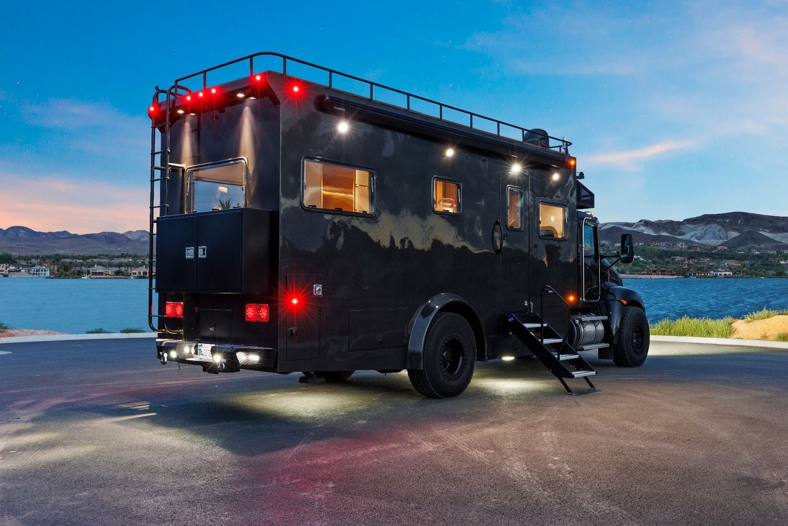 2017 Global Expedition Vehicles The Beast rear three-quarter view from the passenger side showing the rear cargo cabinet, tail lights and rear bumper with integrated work lights