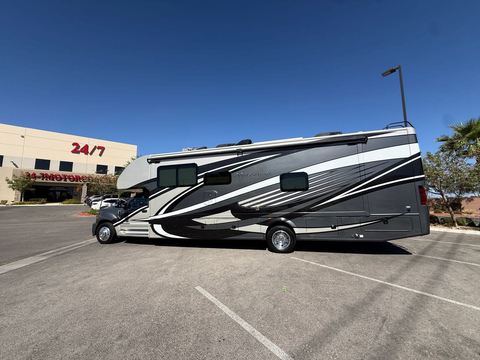 2020 Thor Magnitude BH35 full driver-side profile, showing the unbroken flank with sliding windows and the awning rail above