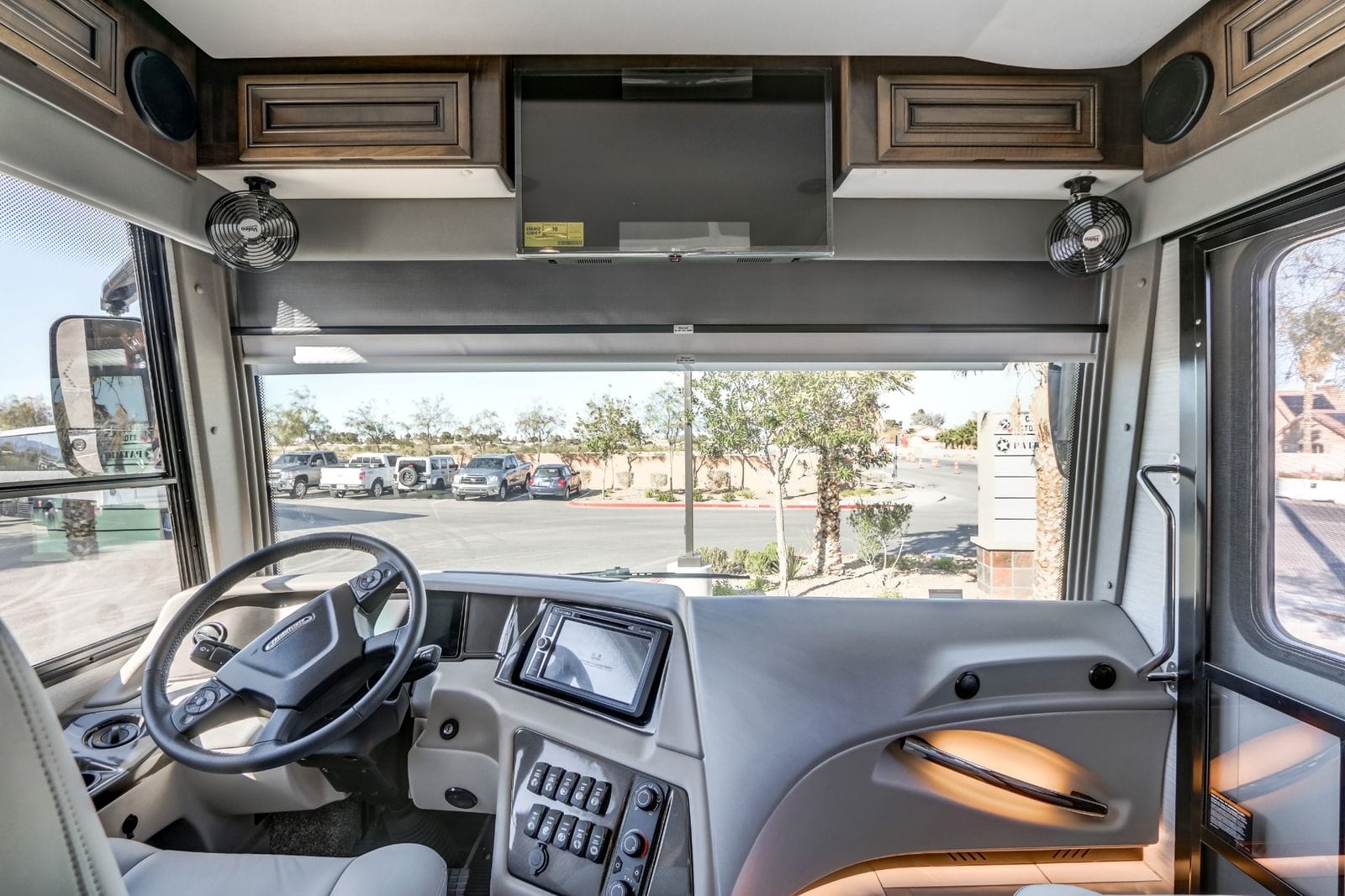 2024 Forest River Berkshire XL 40E cockpit with Freightliner steering wheel, touchscreen infotainment dash, overhead LED TV and dual Valeo fans