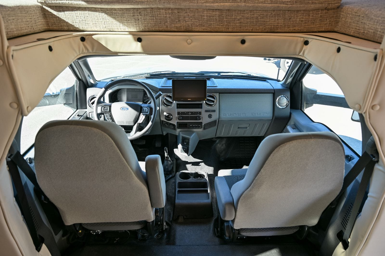 2026 Nexus Maximus 34MX Ford Super Duty cockpit seen from the coach with both captain's chairs, dash and Sony touchscreen