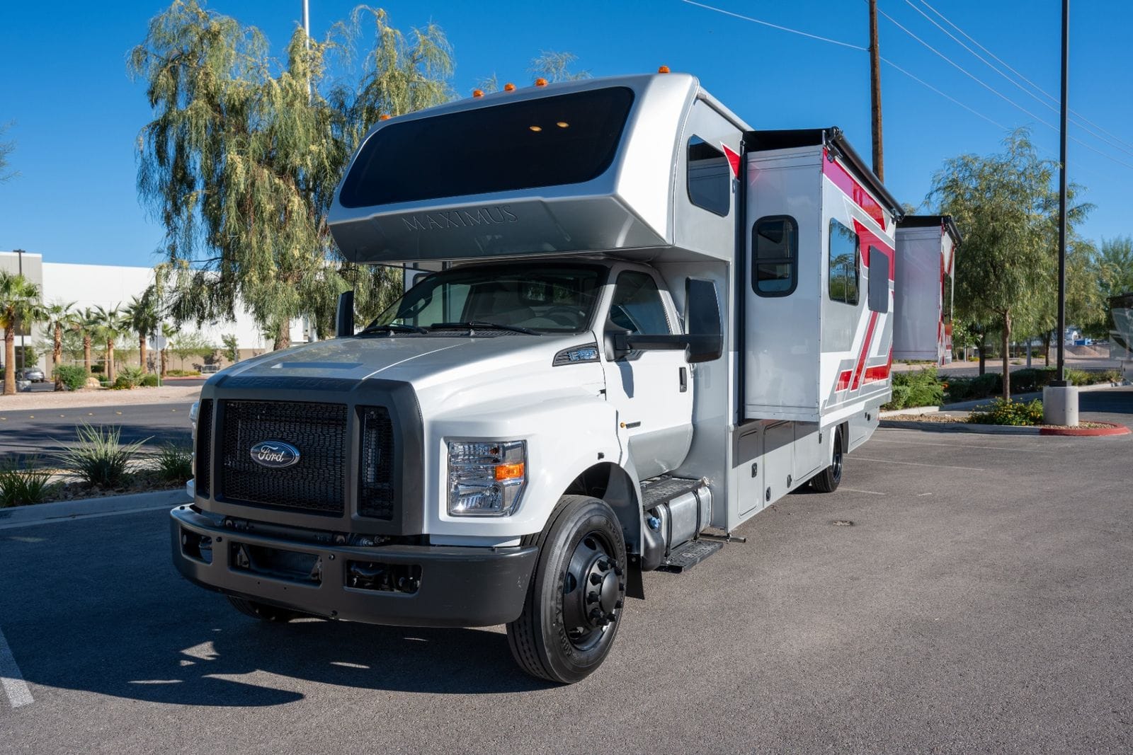 2026 Nexus Maximus 34MX low front driver's-side three-quarter view of the Ford F-650 Super Duty chassis, grille and 22.5-inch wheels