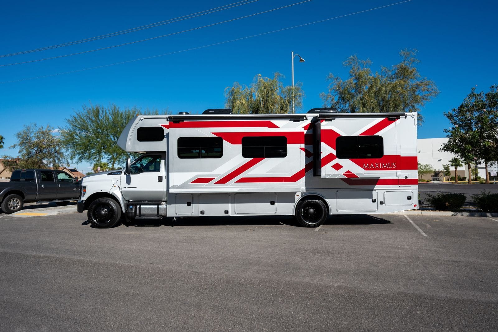 2026 Nexus Maximus 34MX driver's-side profile of the 34-foot Super C with awning rails and lower storage compartments