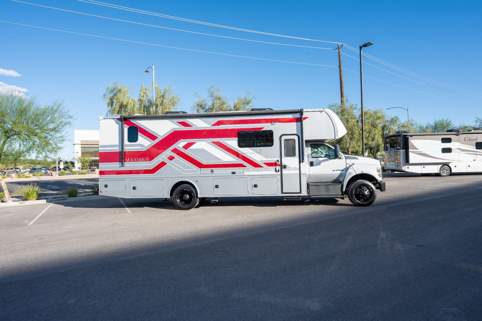 2026 Nexus Maximus 34MX full passenger-side profile with entry door, awning rail and roof air conditioners