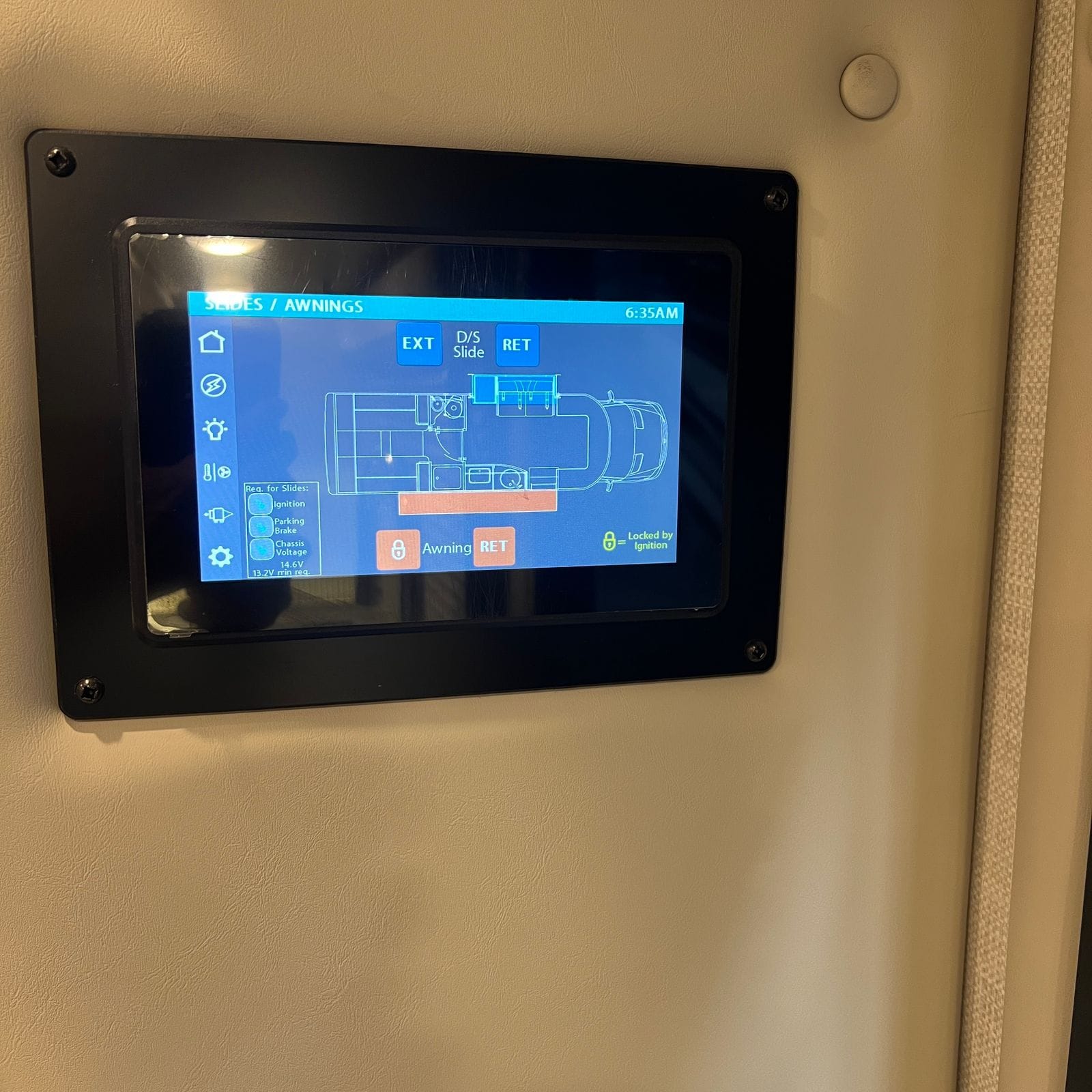 2026 Thor Delano 24XL wall-mounted touchscreen control panel on the slides and awnings page showing extend and retract controls and chassis voltage