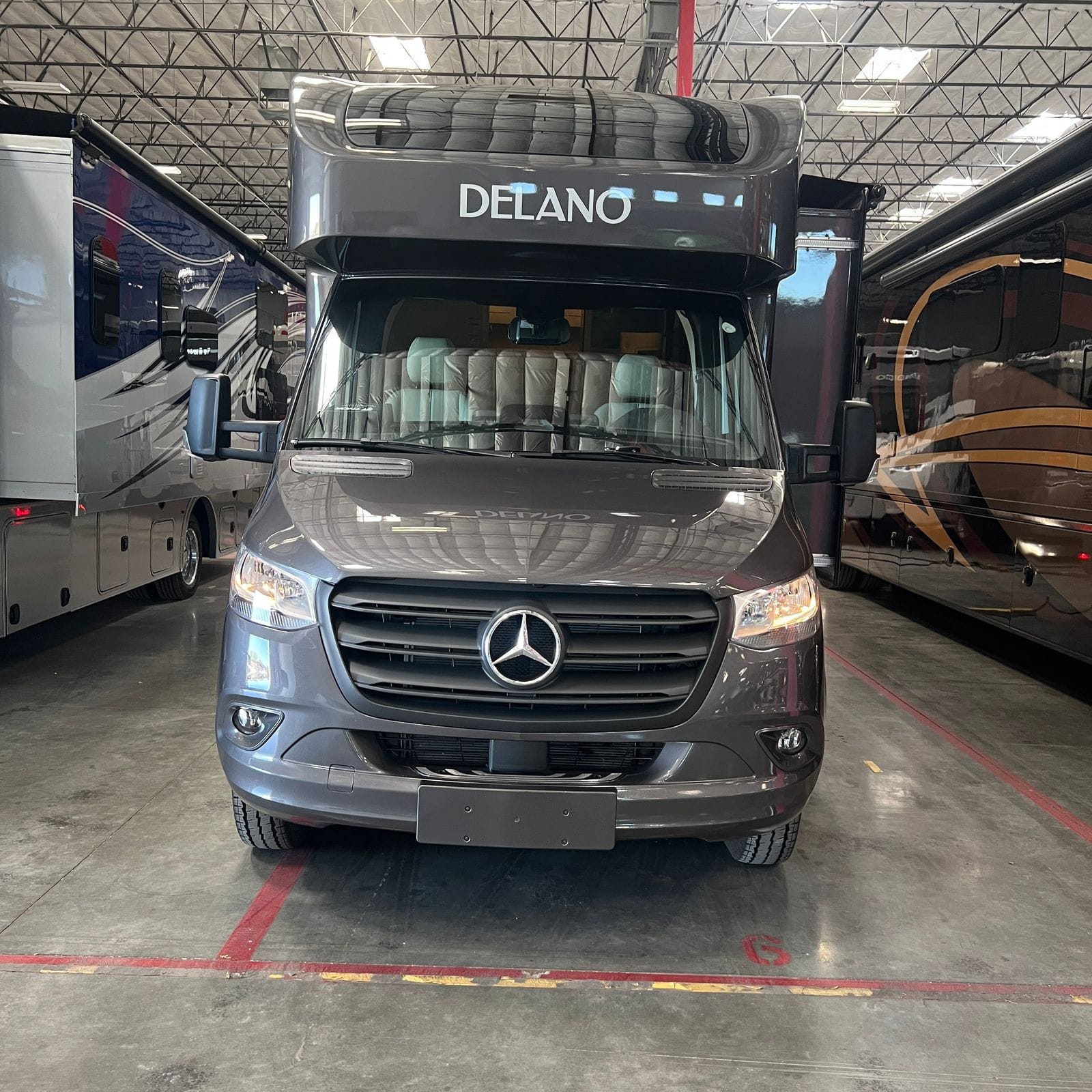 2026 Thor Delano 24XL straight-on front view showing the Mercedes-Benz Sprinter grille and star badge, Delano lettering across the cab-over cap and dual mirrors