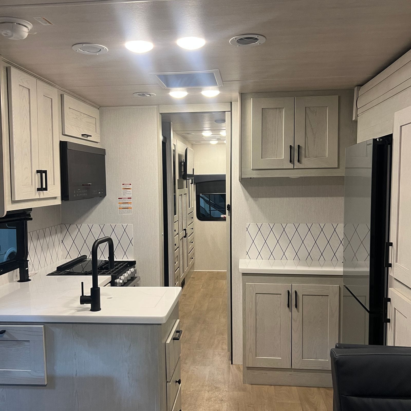 2027 Nexus Rebel 34R kitchen with refrigerator and hallway
