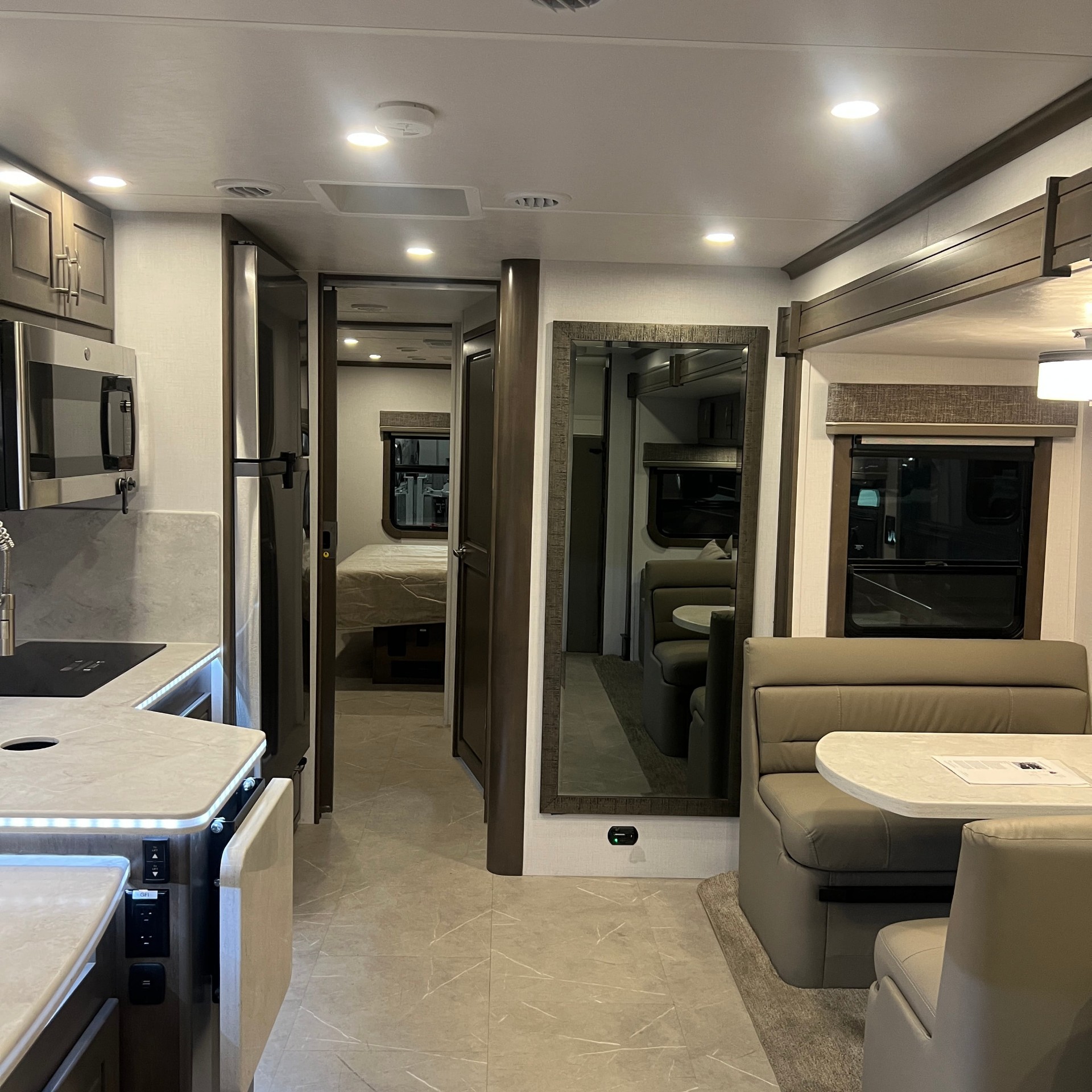 Interior of the Dynamax DX3 37BD Super C, looking from the living area toward the cockpit
