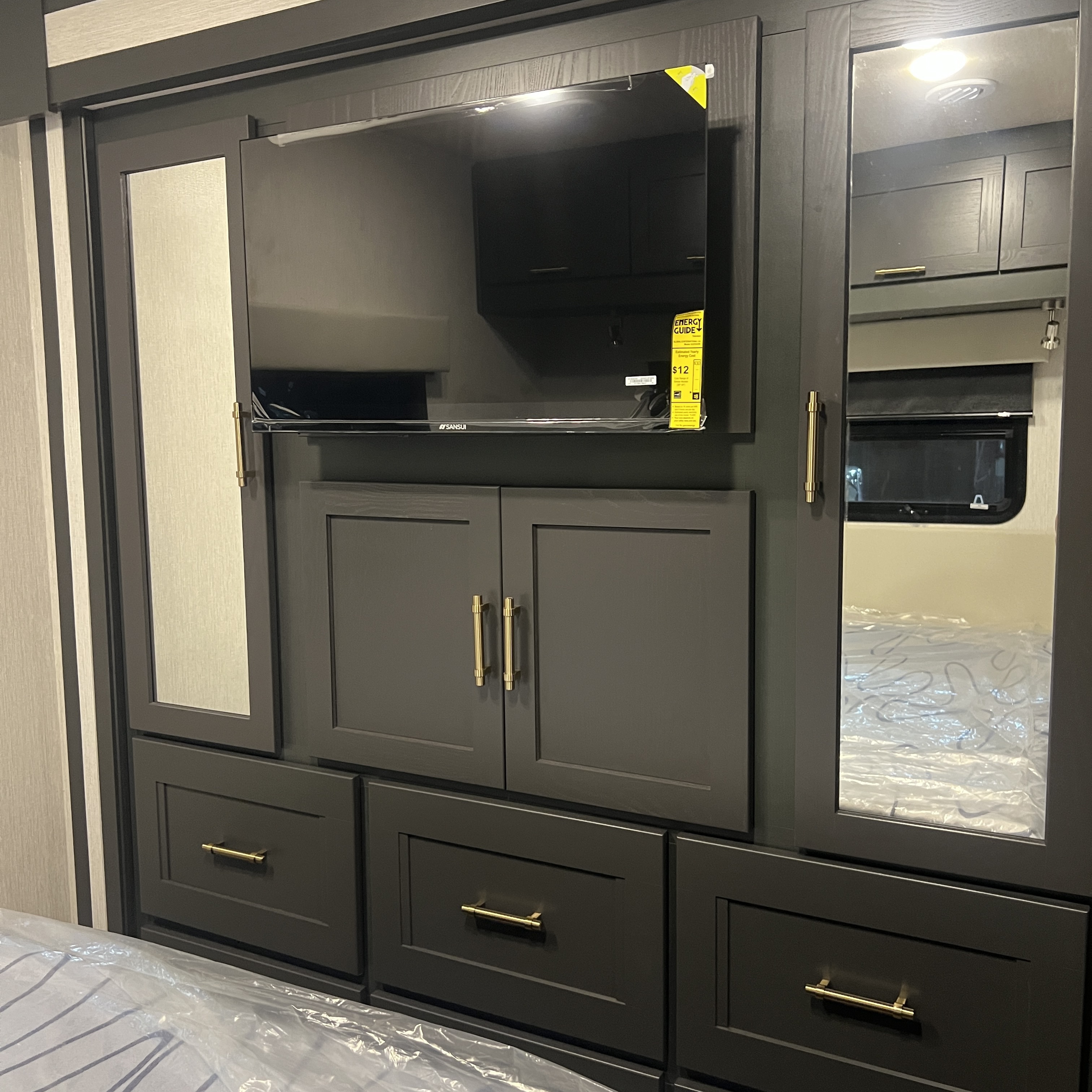 2027 Nexus Rebel Air 35R rear bedroom with wardrobe and wall-mounted TV