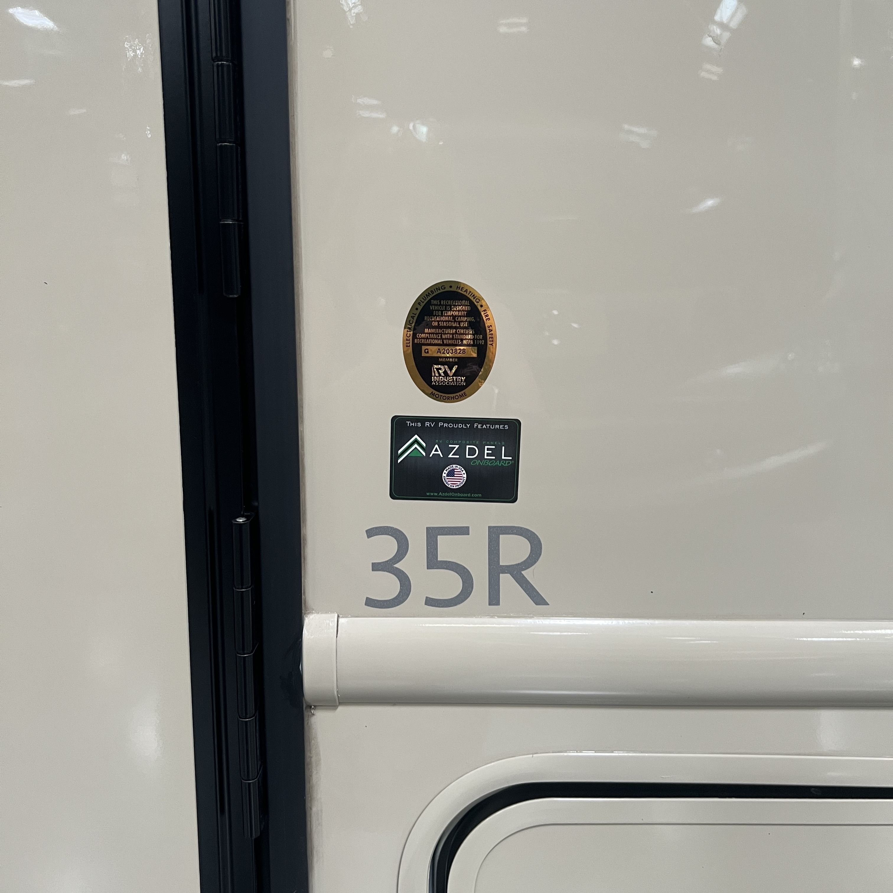 2027 Nexus Rebel Air 35R door detail with 35R model badge and Azdel construction badge