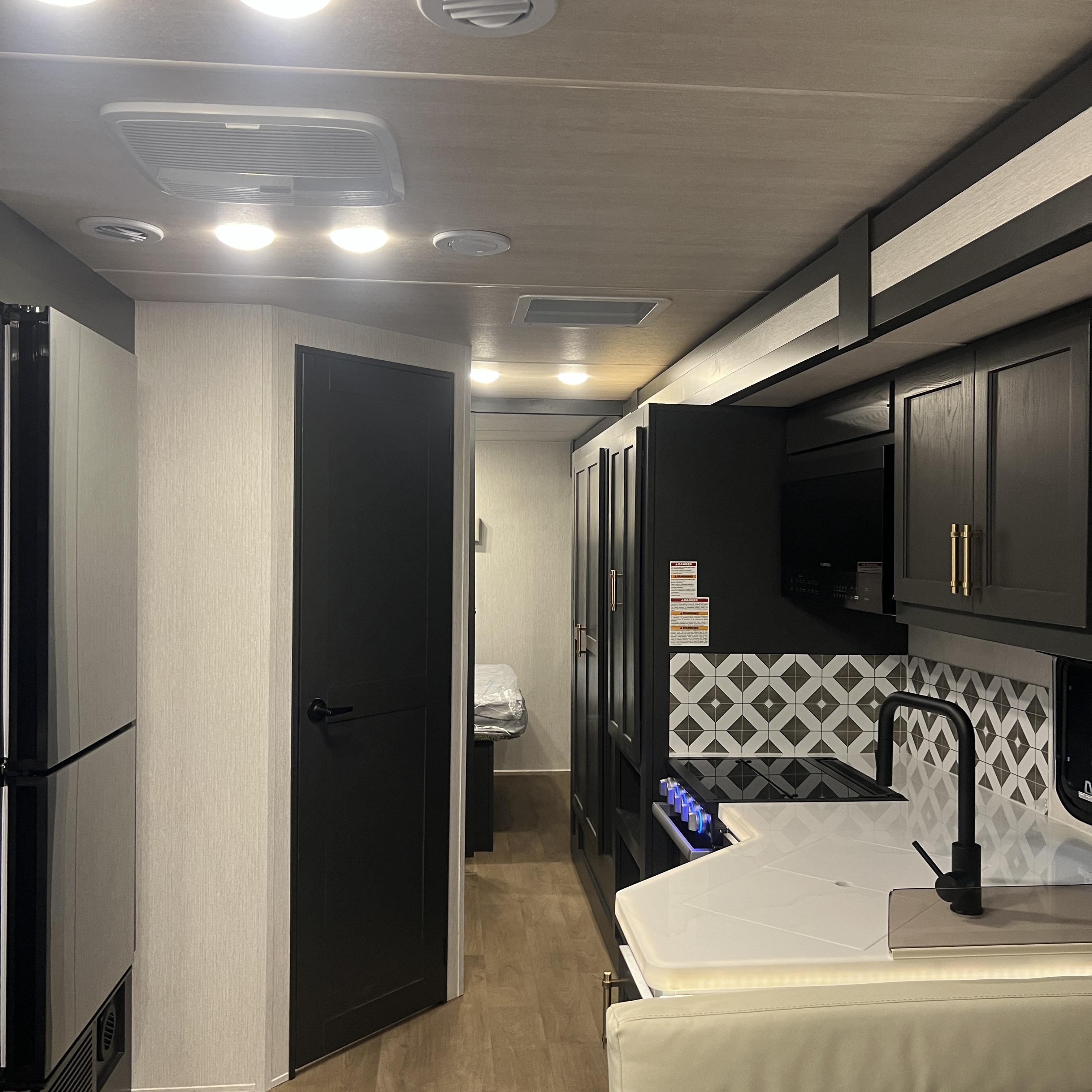 2027 Nexus Rebel Air 35R kitchen with patterned tile backsplash, view toward the bedroom